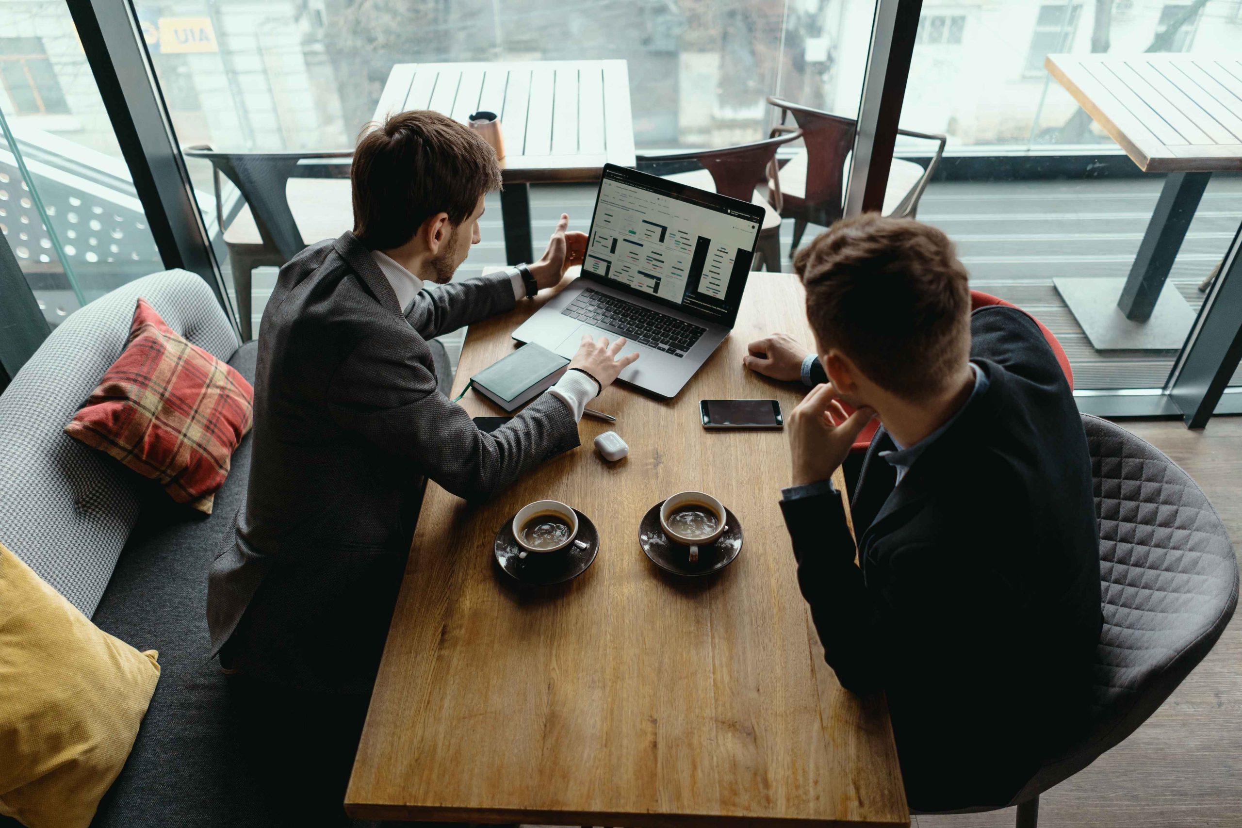 two-young-businessman-having-successful-meeting-restaurant_11zon Office Meeting